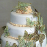 Stacked rolled fondant wedding cake with butterfly cascade