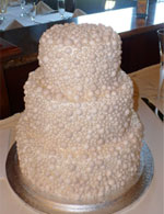 Wedding cake covered in pearls.