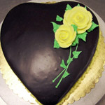 Heart-shaped cake with yellow roses.